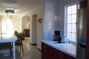 a kitchen and a living room with a counter top at Luxury Home Ixtapa Balcony Pool BBQ AA WIFI 250mbs! in Ixtapa