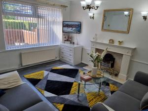 a living room with a table and a fireplace at Glamorous room with WiFi and Netflix in Leeds