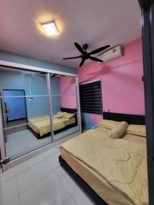 a bedroom with two beds and a ceiling fan at ADN LUXURY Homestay KARAOKE, POOL,NETFLIX,ASTRO,BBQ in Port Dickson