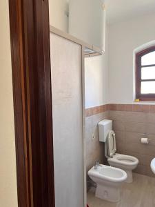 a bathroom with a toilet and a sink at Maison Umberto I a Villasimius centro in Villasimius +15 photos