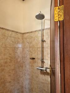 La salle de bains est pourvue d'une douche avec une porte en verre. dans l'établissement Baruna Cottages, à Kintamani