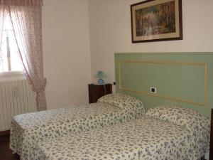 a hotel room with two beds and a window at La Corte Del Cavaliere Bed & Breakfast in Calderara di Reno