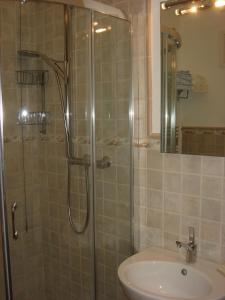 a bathroom with a shower and a sink at La Corte Del Cavaliere Bed & Breakfast in Calderara di Reno