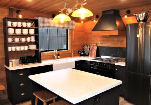 a kitchen with a black refrigerator and a counter top at The Bavarian Chalet in Ohakune
