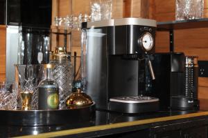 a coffee machine sitting on a counter with glasses at The Bavarian Chalet in Ohakune