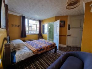 a bedroom with a bed and a window at THE PRINCE OF GREENWICH Museum Pub in London