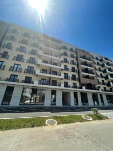 a large apartment building with the sun in the sky at AD luxury in Podgorica