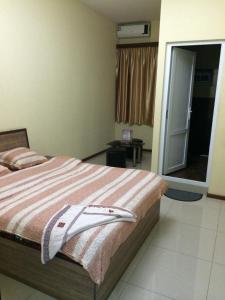 a bedroom with a bed with a towel on it at Star Hotel Didube in Tbilisi City