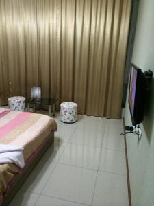 a bedroom with a bed and a flat screen tv at Star Hotel Didube in Tbilisi City
