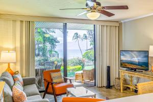 a living room with a view of the ocean at Polynesian Shores 118 in Kahana