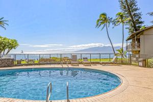 a swimming pool with a view of the ocean at Polynesian Shores 118 in Kahana