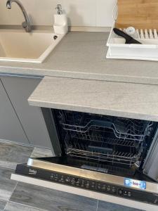 an oven in a kitchen with a counter top at Alesandru apartament in Piteşti