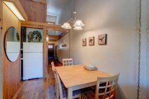 a kitchen and dining room with a table and a refrigerator at Make Way for the Mountains in Truckee
