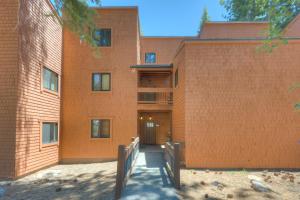 a brick building with a door and a wooden fence at Make Way for the Mountains in Truckee