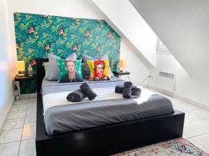 a bedroom with a large bed with a large wall at La Suite Frida, Cosy & Quiet in Beauvais