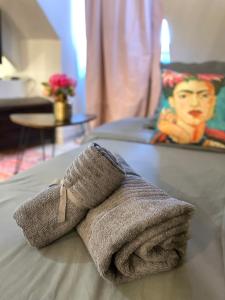 a towel sitting on top of a bed at La Suite Frida, Cosy & Quiet in Beauvais