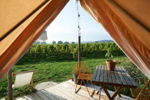 a tent with a table and a potted plant at Coasters Hideaway boutique Glamping in Brunnby