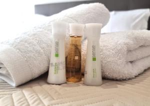 a group of four bottles of sunscreen sitting on a bed at Dream Home Veria in Veria