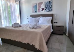 a bedroom with a large bed with two towels on it at Dream Home Veria in Veria