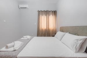 Postel nebo postele na pokoji v ubytování THALASSA ALMYROS APARTMENTS