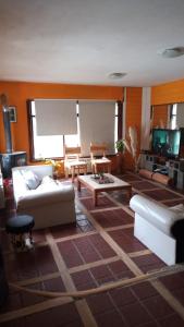 a living room with a couch and a table at Posada Copahue in San Carlos de Bariloche