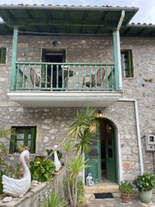 a building with a balcony with two swans on it at Petra Maisonettes in Kariá