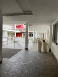 an empty room with columns and stairs in a building at Aury & Ester Casa Vacanze in Crema