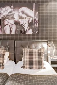 1 dormitorio con 1 cama con una foto en la pared en ZE Hotel, en París