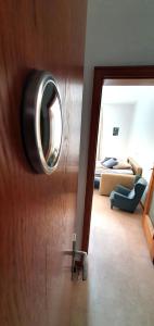 a room with a door with a mirror and a couch at Zweizimmer-Wohnung mit Parkgarage in Naturno