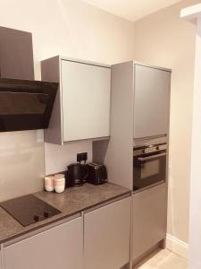 a kitchen with stainless steel cabinets and a stove at 'Fairfield' at stayBOOM in Lancaster