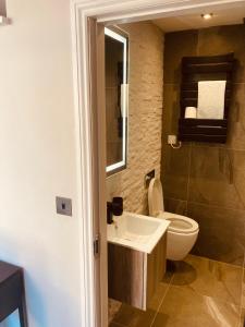 a bathroom with a toilet and a sink at 'Fairfield' at stayBOOM in Lancaster