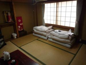a living room with a couch and a window at Daiya Ryokan in Kyoto