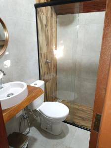 a bathroom with a toilet and a sink and a shower at Rancho Pôr Do Sol in Arapeí