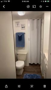 a bathroom with a toilet and a blue towel at NEW Fort Myers Beach RV Resort 2 Bedroom 1 Bath in Fort Myers