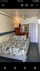 a bedroom with a bed and a mirror and a bed sidx sidx sidx at NEW Fort Myers Beach RV Resort 2 Bedroom 1 Bath in Fort Myers
