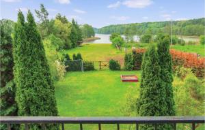 a view of a garden with a bench and trees at Amazing Home In Kolczewo With Sauna in Kołczewo