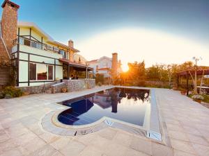 a swimming pool in the backyard of a house at 4 Bedroom Deluxe Villa with Mountain and Sea View in Kérynia