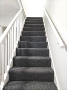 a flight of stairs in a house at Remaj Service Accommodation, Sleep 7 in Dagenham