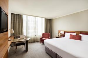 a hotel room with a bed and a desk with a laptop at View Melbourne in Melbourne