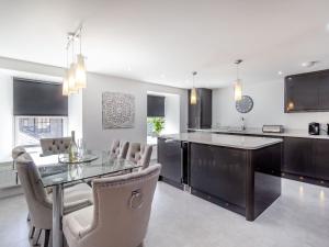 a kitchen and dining room with a table and chairs at Queen Victoria Suite in Stanhope