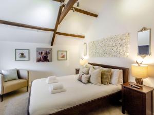 a bedroom with a large white bed and a chair at Queen Victoria Suite in Stanhope