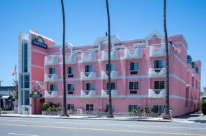 a pink building on the side of a street at Days Inn by Wyndham Santa Monica/Los Angeles in Los Angeles