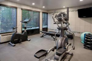 a gym with two treadmills and two exercise bikes at SureStay Plus Hotel by Best Western Reno Airport in Reno