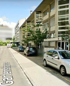 una strada con auto parcheggiate sul lato di un edificio di Ferienwohnung in Zentrale Lage a Berna