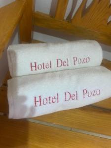 two towels with the words hotel del polo on them at Hotel del Pozo in San Sebastián del Oeste