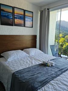 Postel nebo postele na pokoji v ubytování Alto da Piraquara Flat