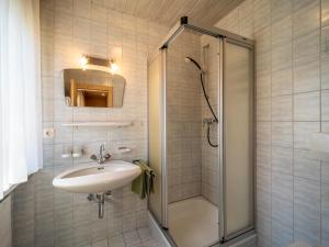 a bathroom with a sink and a shower at Panorama I in Mayrhofen