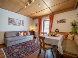 a living room with a table and a couch at Panorama I in Hollenzen