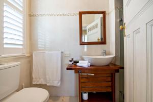 a bathroom with a sink and a toilet and a mirror at The Westbury Dubbo in Dubbo