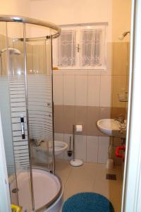 a bathroom with a shower and a sink at Apartments by the sea Mimice, Omis - 656 in Mimice